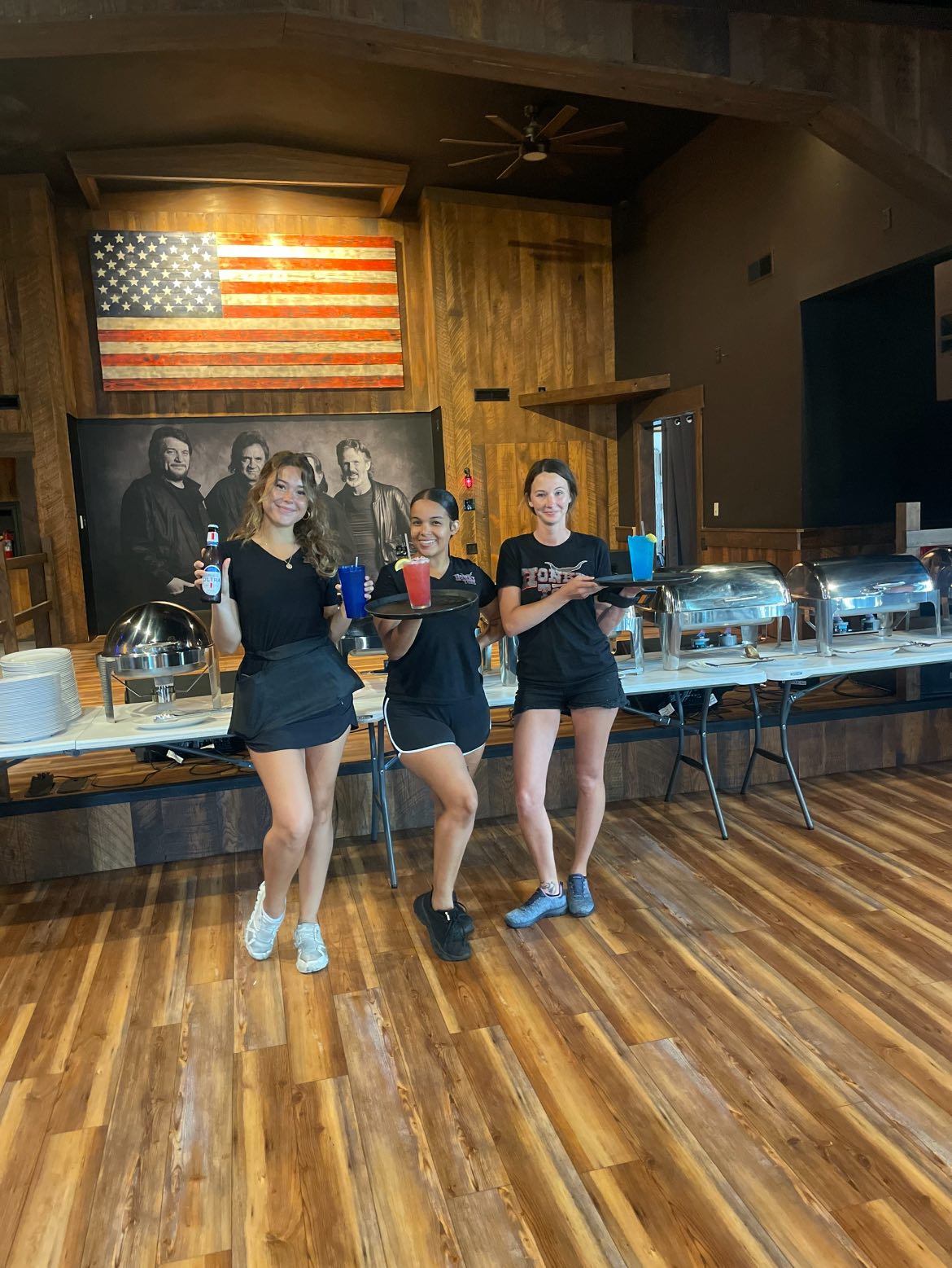 Servers with drink trays at Honky Tonk Troy