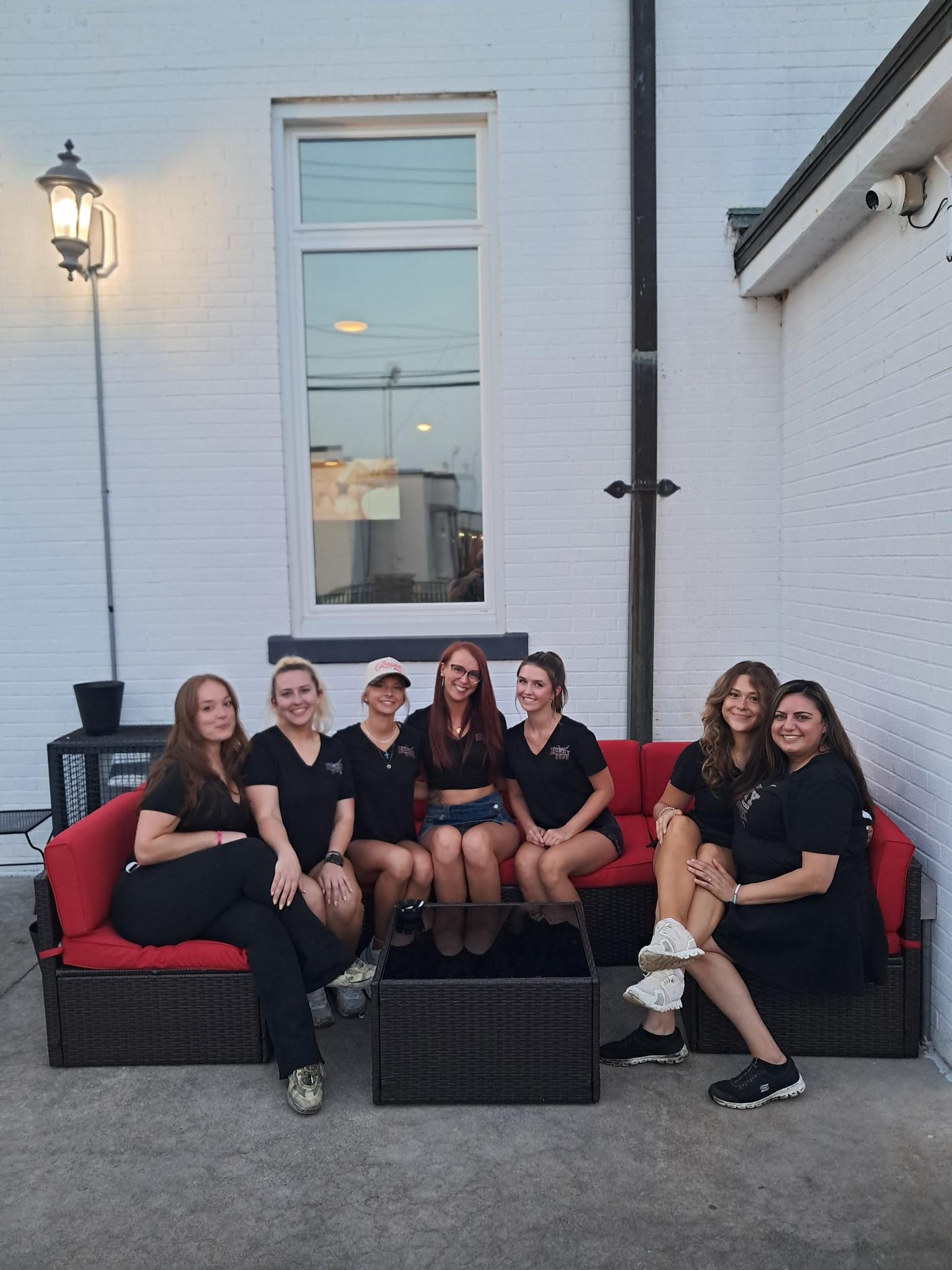 Staff on the red patio couch after a shift